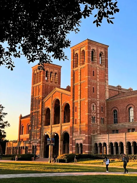 UCLA’s red-brick Royce Hall and twin towers in warm evening light.
